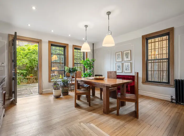For $2.5M, this compact Harlem carriage house has a backyard, garage, and room to expand