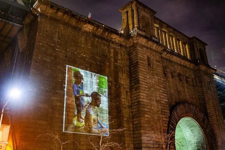 New exhibit projects photos of pandemic parenting moments onto the Manhattan Bridge